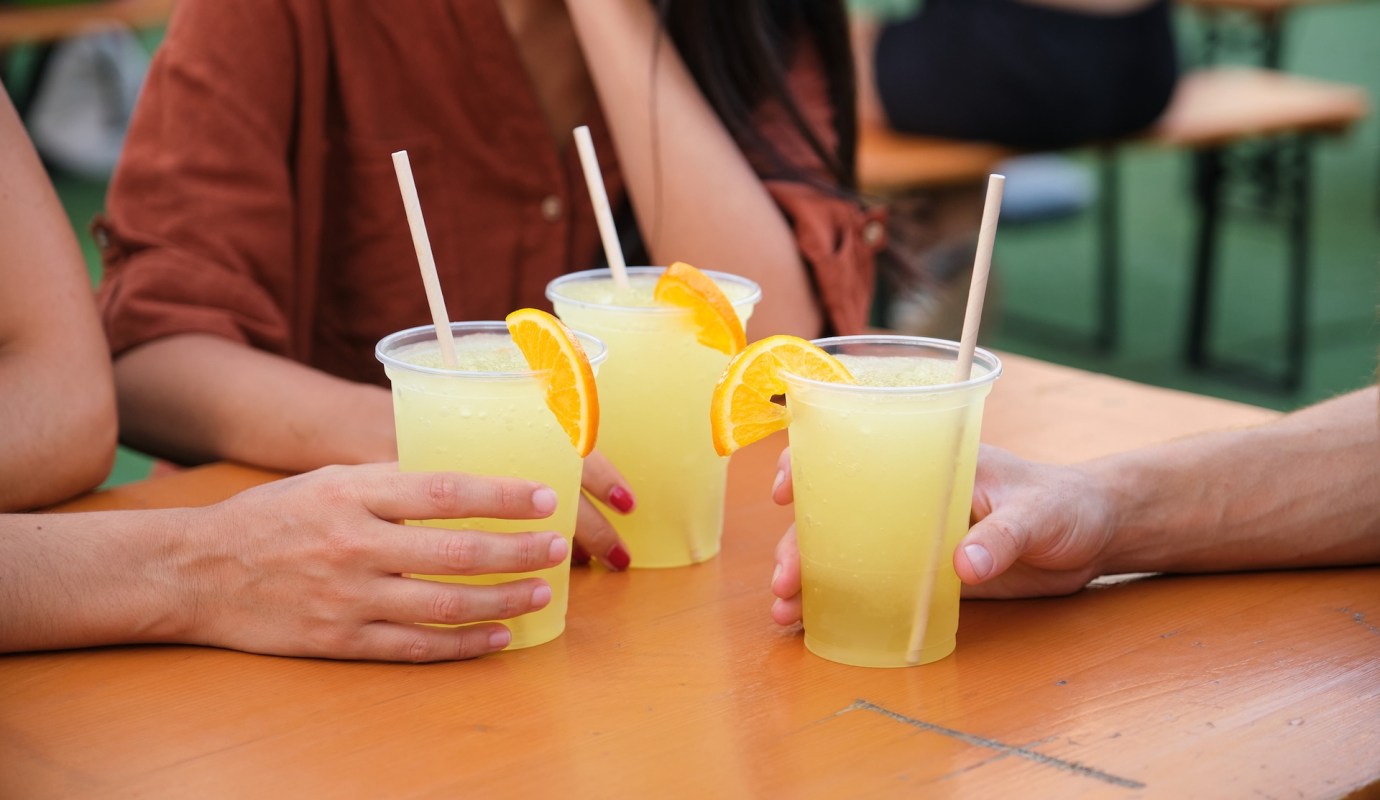Three lemonades with straws.