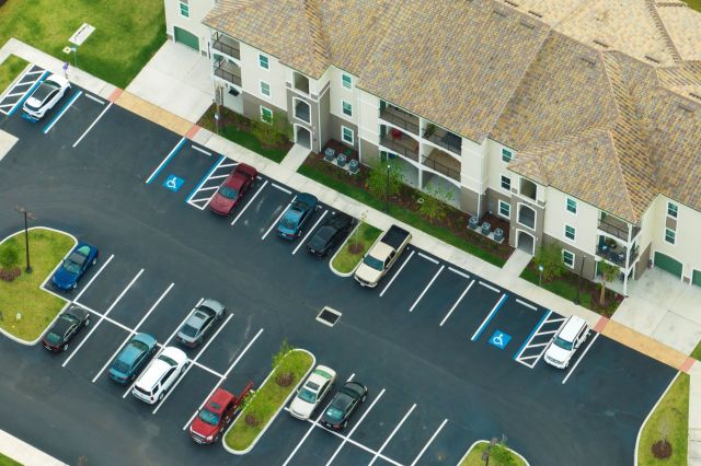 Parking outside of an apartment building.
