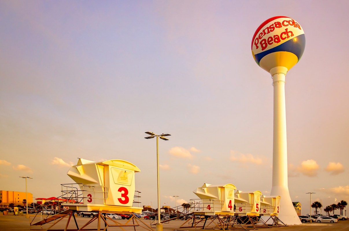 A water tower labeled "Pensacola Beach" next to beach lifeguard stations numbered 2, 3, 4, and 5.