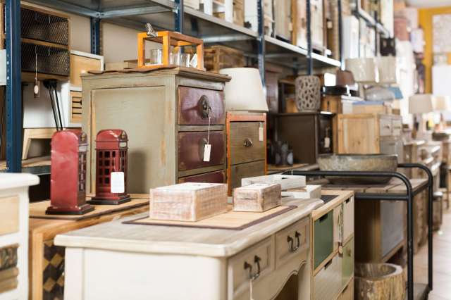 A variety of furniture pieces and decorative items displayed in a store.
