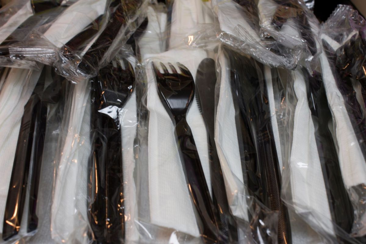 A pile of plastic knives and forks.