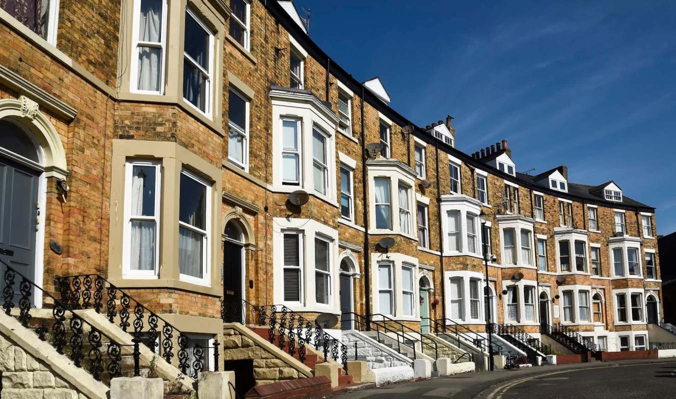 A row of terraced houses with bay windows.