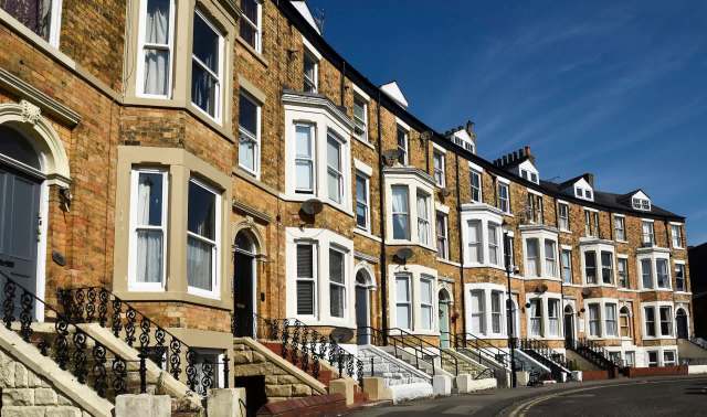 A row of terraced houses with bay windows.