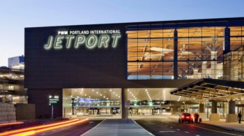 Portland International Jetport building with large windows and illuminated signage.
