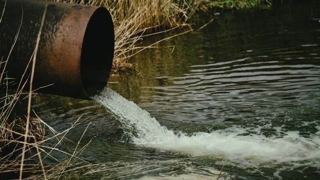 A rusty pipe discharging wastewater.