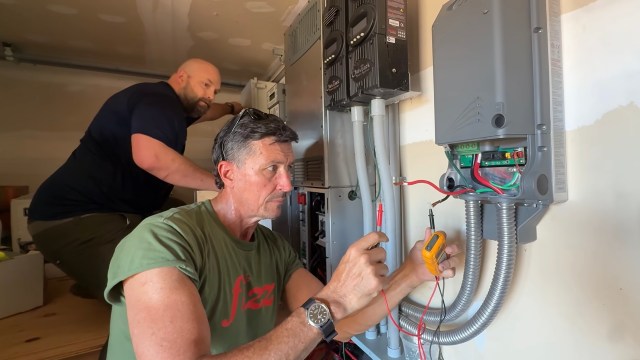 Two men working on an energy storage system.