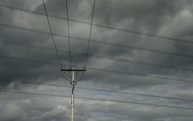 A cloudy sky over power lines.