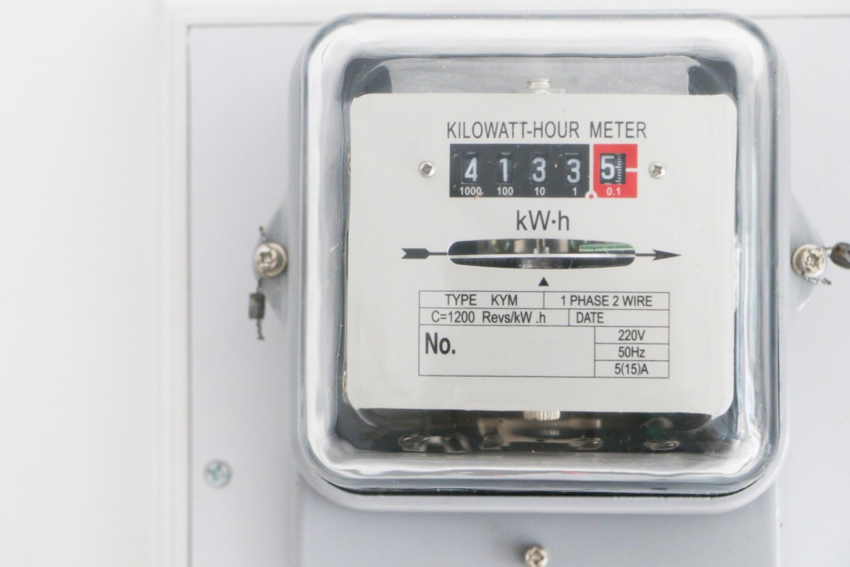A kilowatt-hour meter displaying usage readings on a mounted surface.