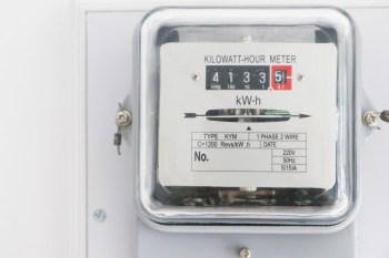 A kilowatt-hour meter displaying usage readings on a mounted surface.