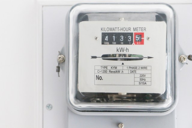 A kilowatt-hour meter displaying usage readings on a mounted surface.