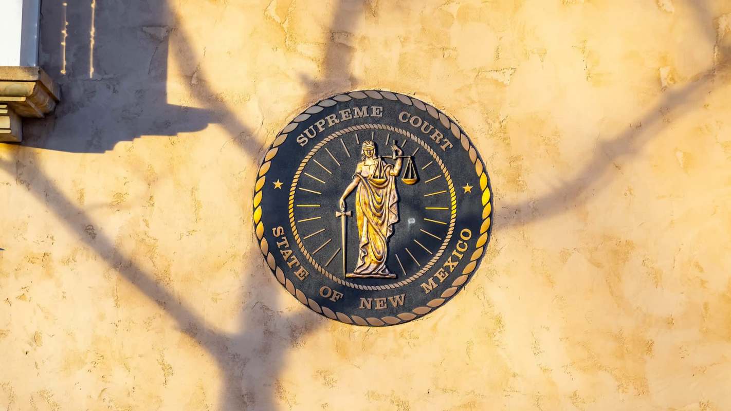 A seal of the Supreme Court State of New Mexico.