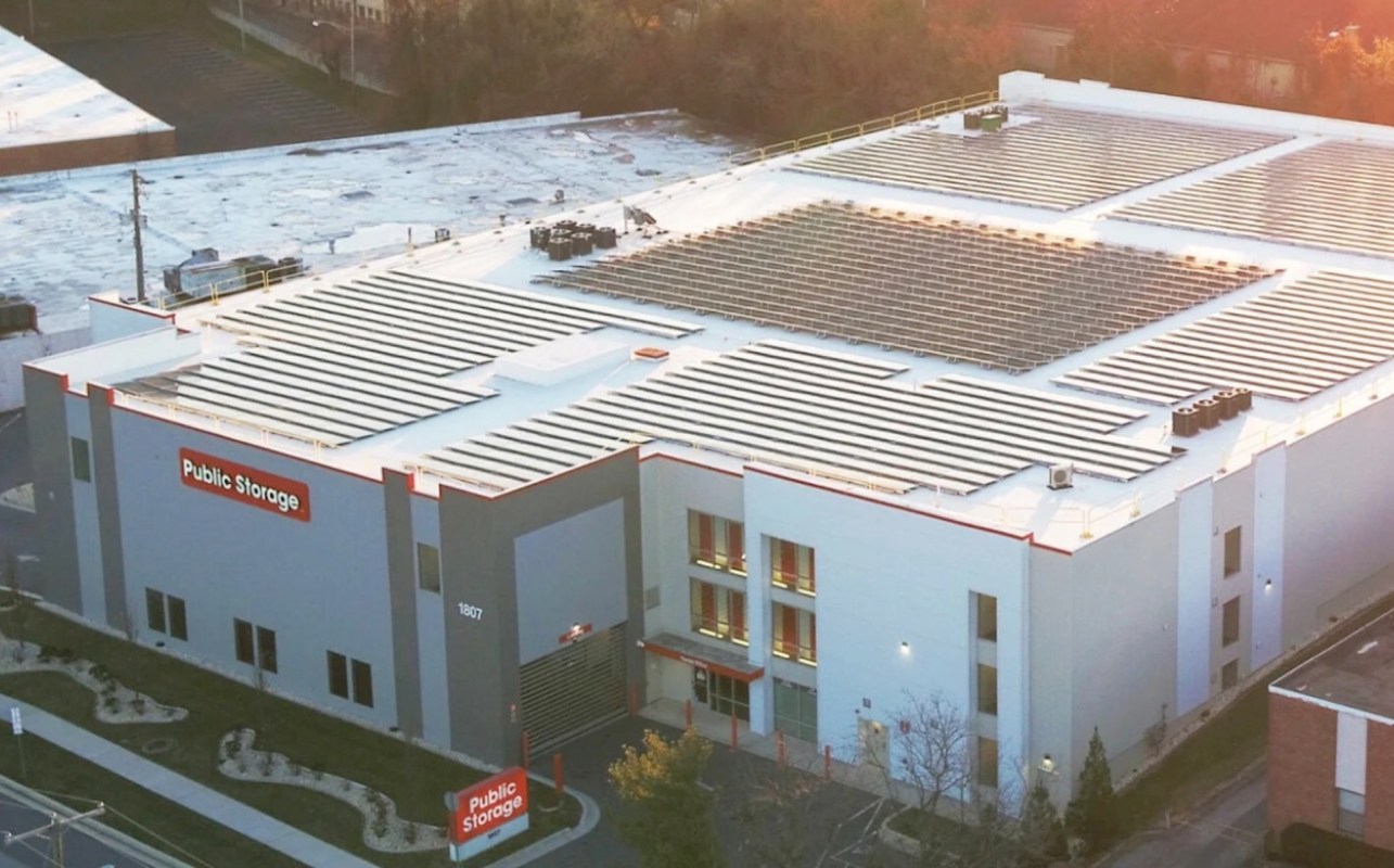 A storage building with solar panels on the roof and a "Public Storage" sign.