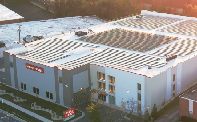 A storage building with solar panels on the roof and a "Public Storage" sign.
