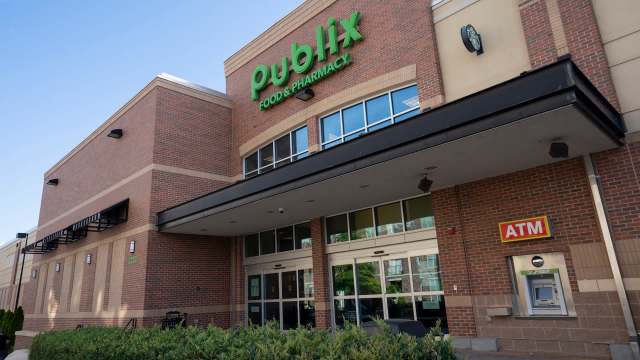 A Publix grocery store entrance with an ATM and Starbucks sign above.