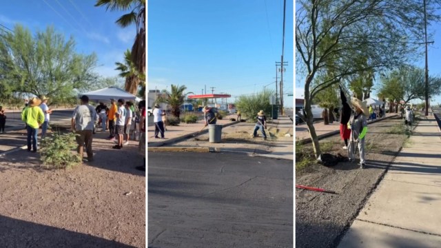 A group of people participate in a community cleanup event alongside a road with desert vegetation.