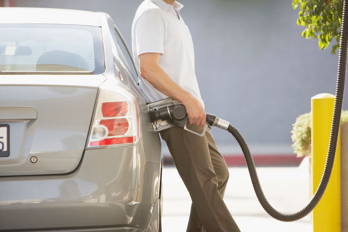 A man pumping gas.