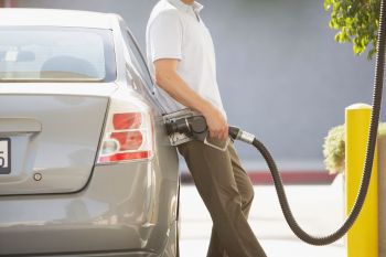 A man pumping gas.
