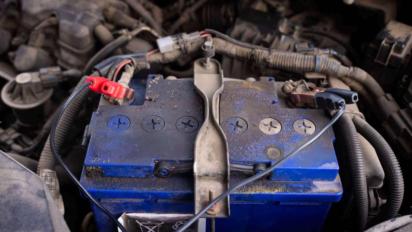 Jumper cables connected to a car battery.