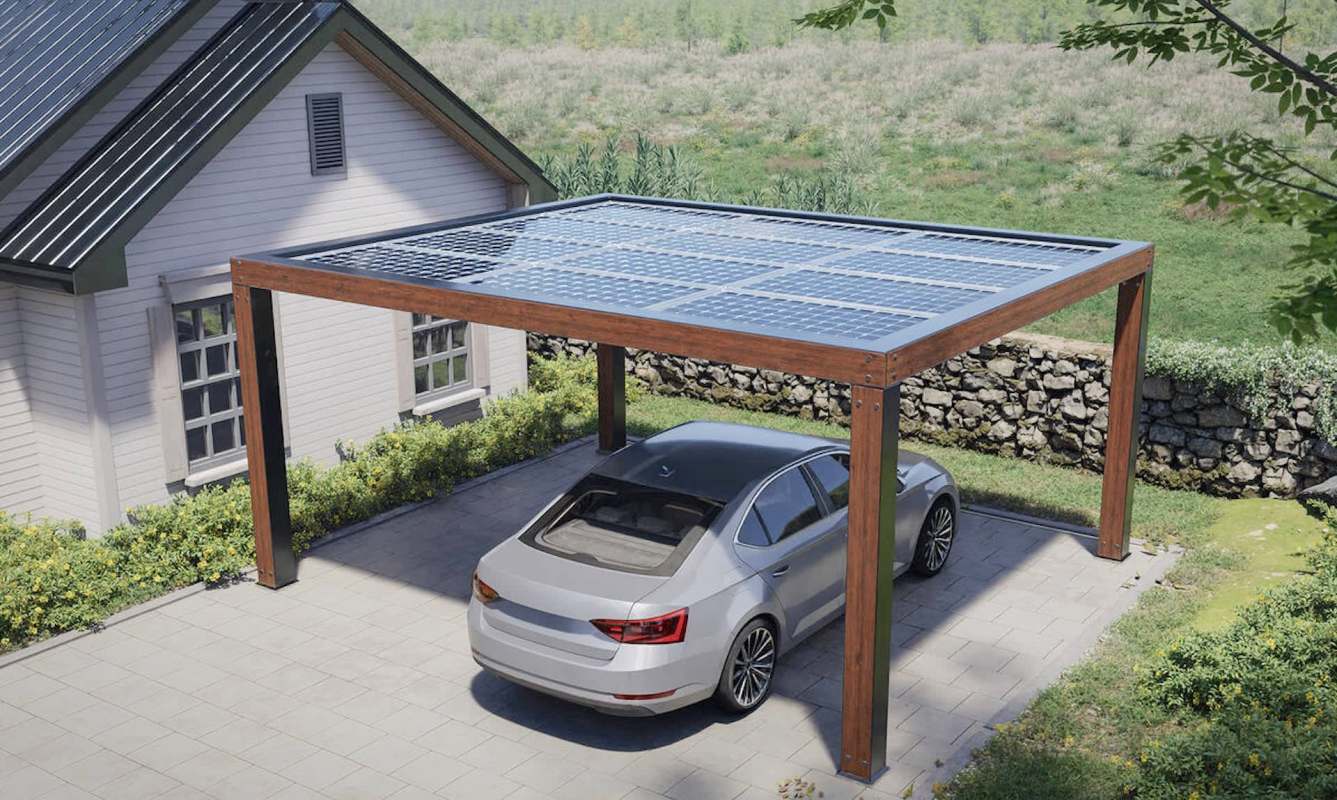 A car parked under a wooden solar panel carport beside a house and green landscape.