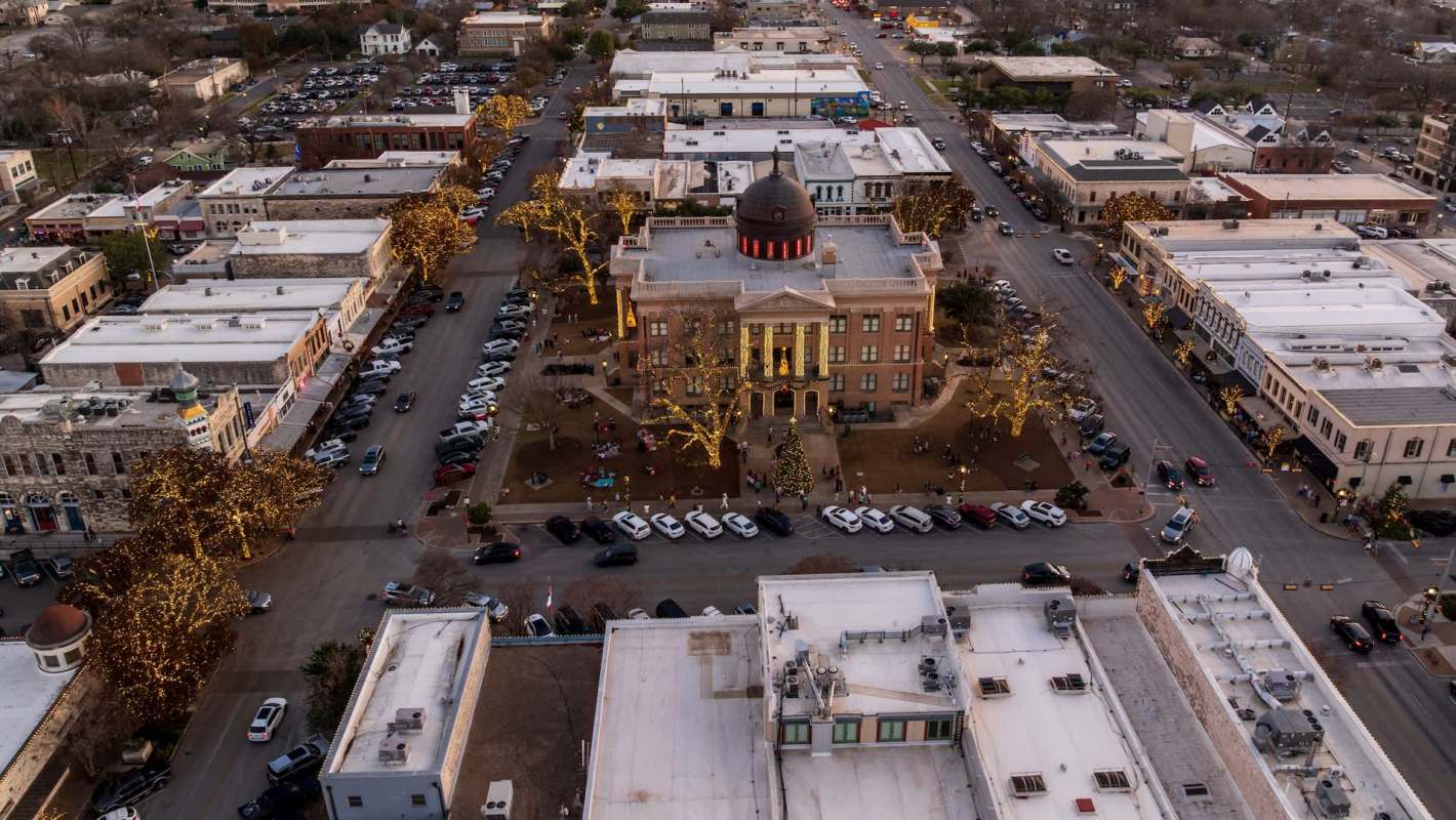 An aerial view of Georgetown, Texas, city square with a historic building and cars.