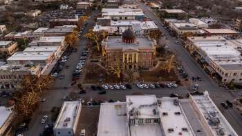 An aerial view of Georgetown, Texas, city square with a historic building and cars.