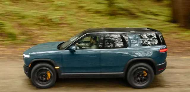 A Rivian driving.