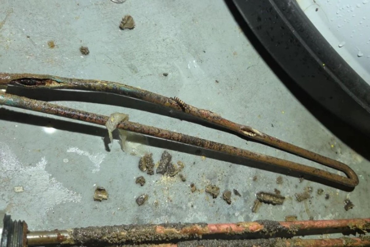 Rusty metal rods and debris scattered on a concrete surface.