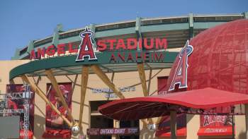 The exterior of Angel Stadium in Anaheim with a large sign and baseball-themed elements.