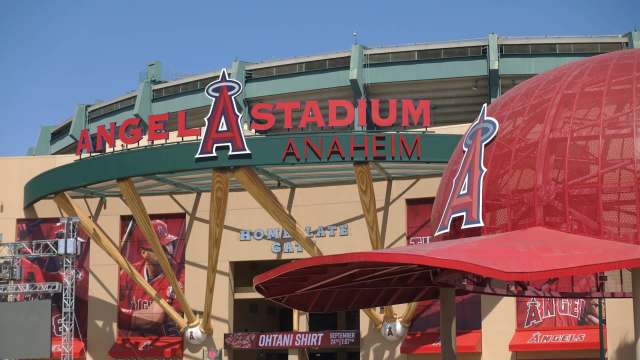 The exterior of Angel Stadium in Anaheim with a large sign and baseball-themed elements.