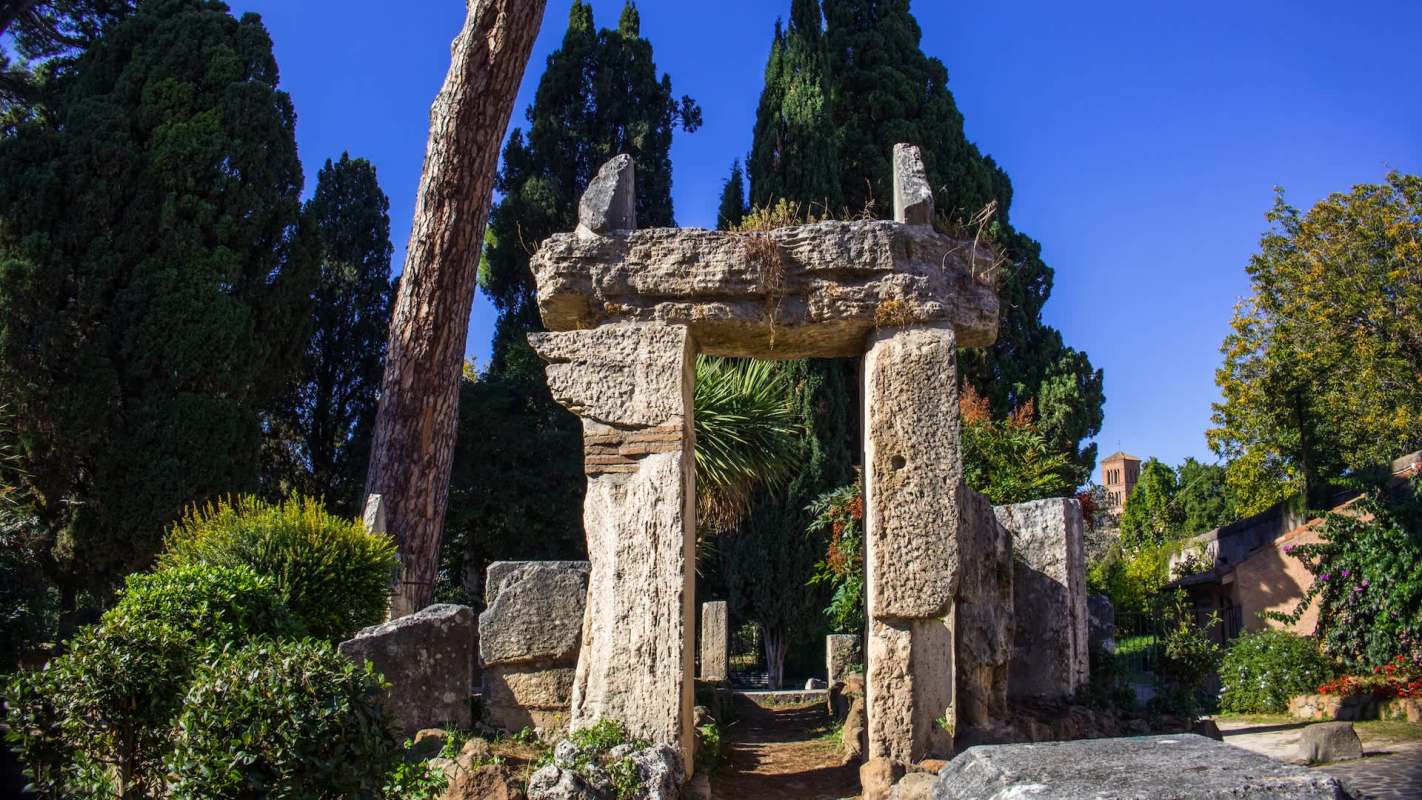 A stone archway in a garden.