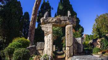 A stone archway in a garden.