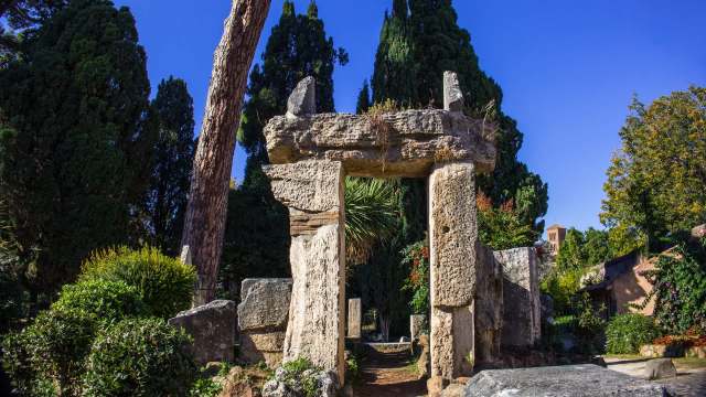 A stone archway in a garden.