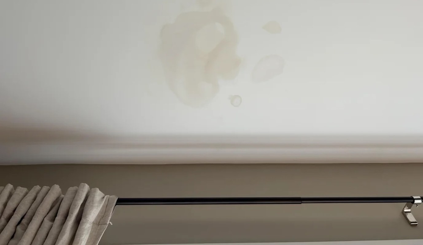 A ceiling with water stains.