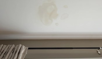 A ceiling with water stains.