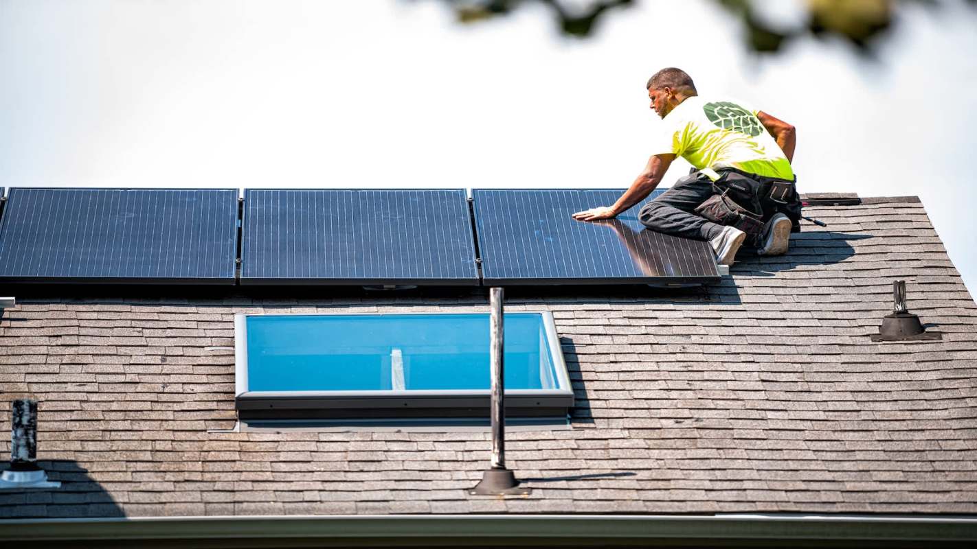 A worker installing solar panels.
