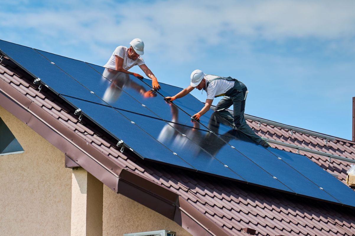 Workers installing rooftop solar.