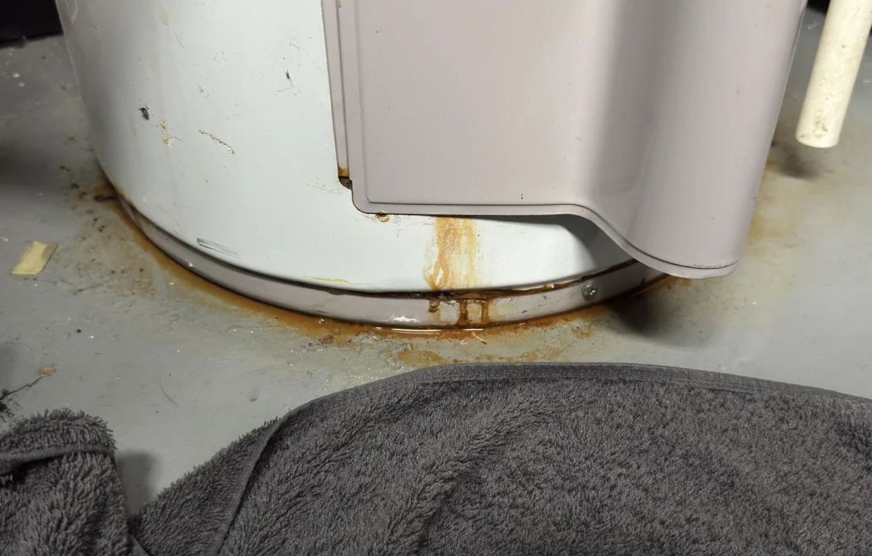 A rusty, leaking water heater.
