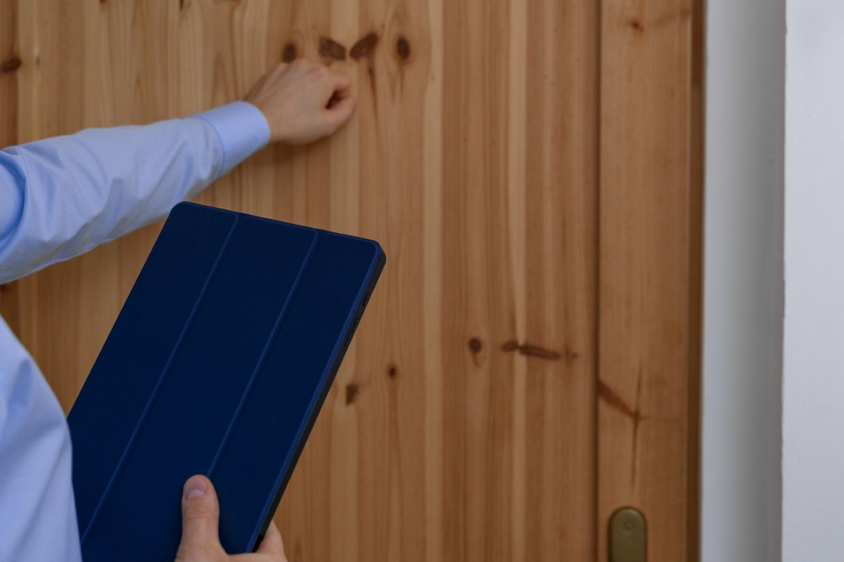 A salesman knocking on a door.