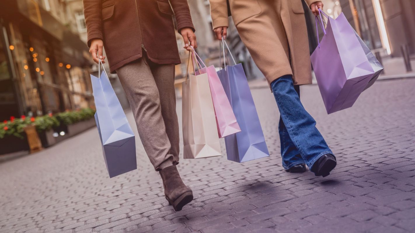 Two people carrying shopping bags.