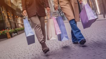 Two people carrying shopping bags.