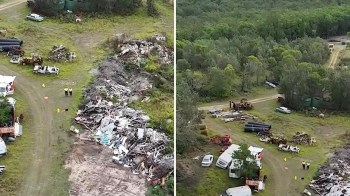 An aerial view showing a cluttered site with scrap materials, vehicles, and trees surrounding the area.