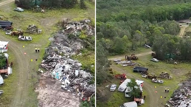 An aerial view showing a cluttered site with scrap materials, vehicles, and trees surrounding the area.