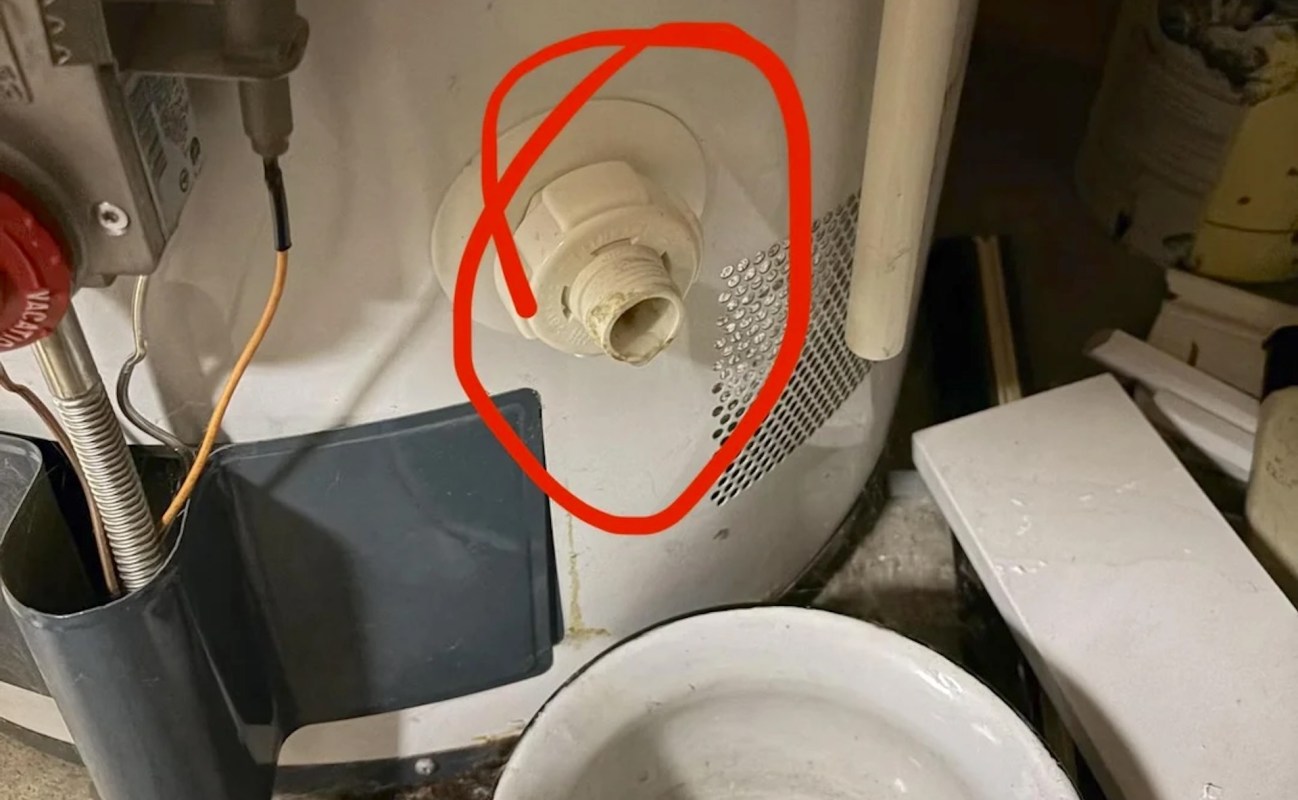 A leaky water heater valve circled in red.