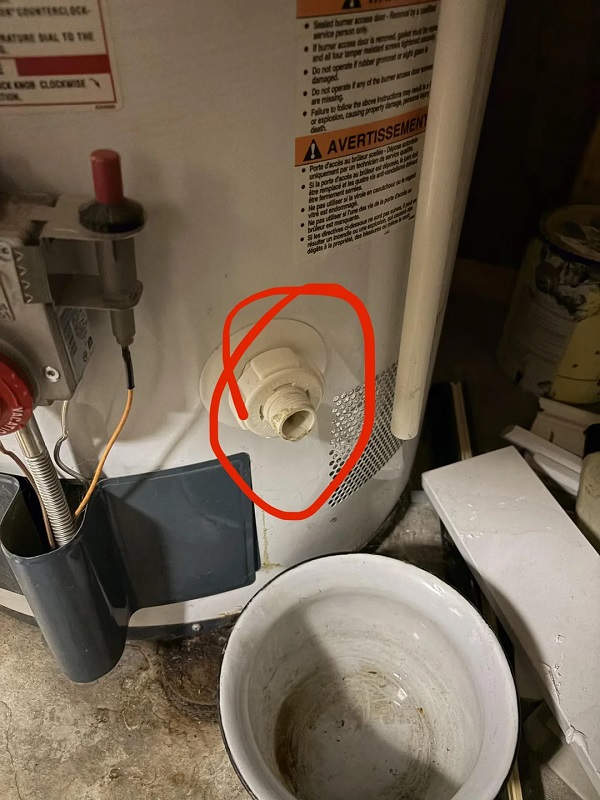 A leaky water heater valve circled in red.