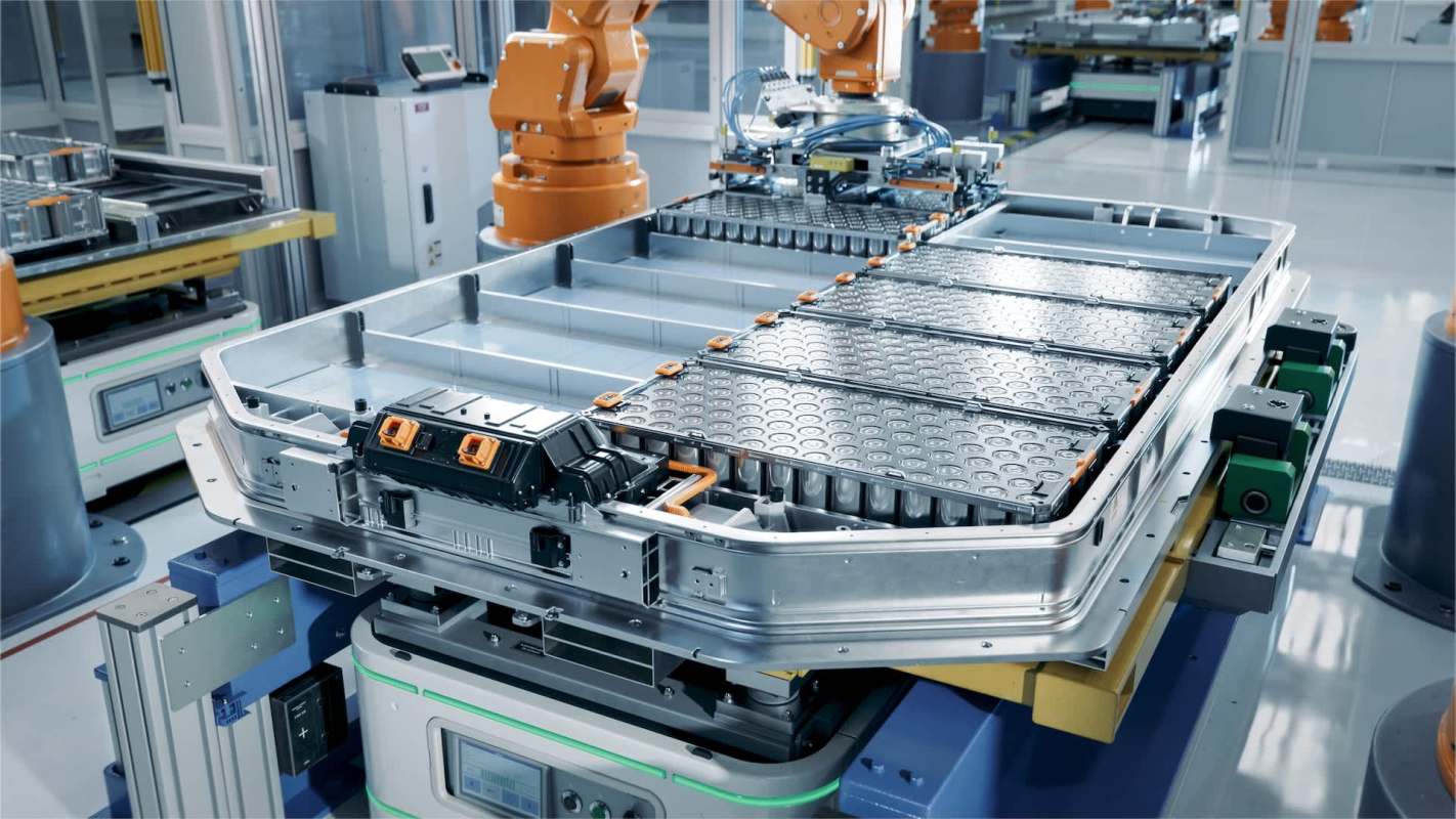 A robotic assembly line working on a battery module within a manufacturing facility.