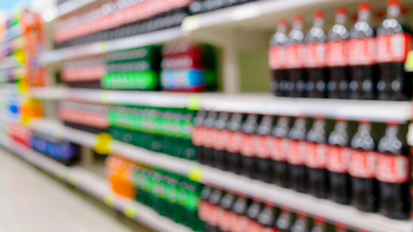 Soda on grocery store shelves.