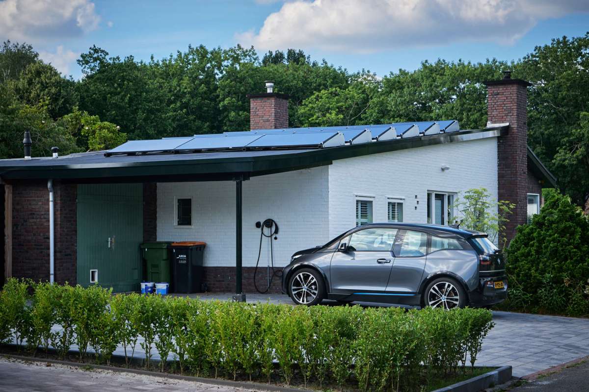 A house with solar panels and an electric vehicle charger.