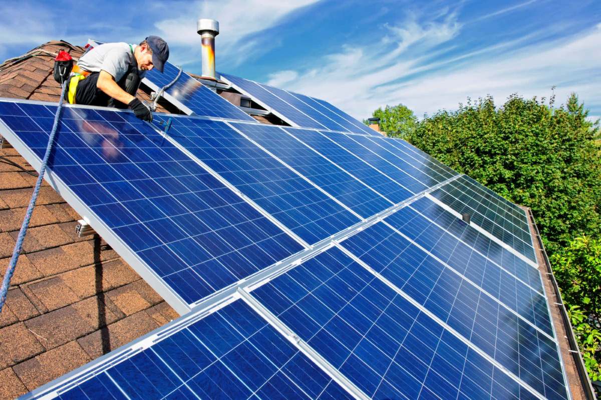 A technician installing rooftop solar.