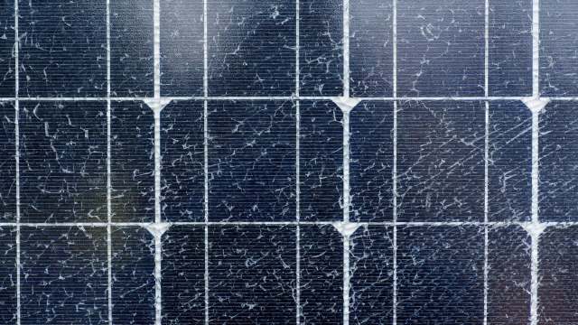 A close-up of a solar panel showing cracks and wear on the surface.