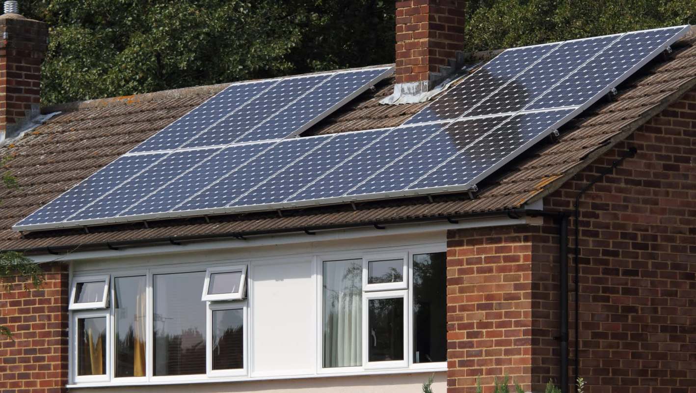 A house with solar panels installed on the roof.